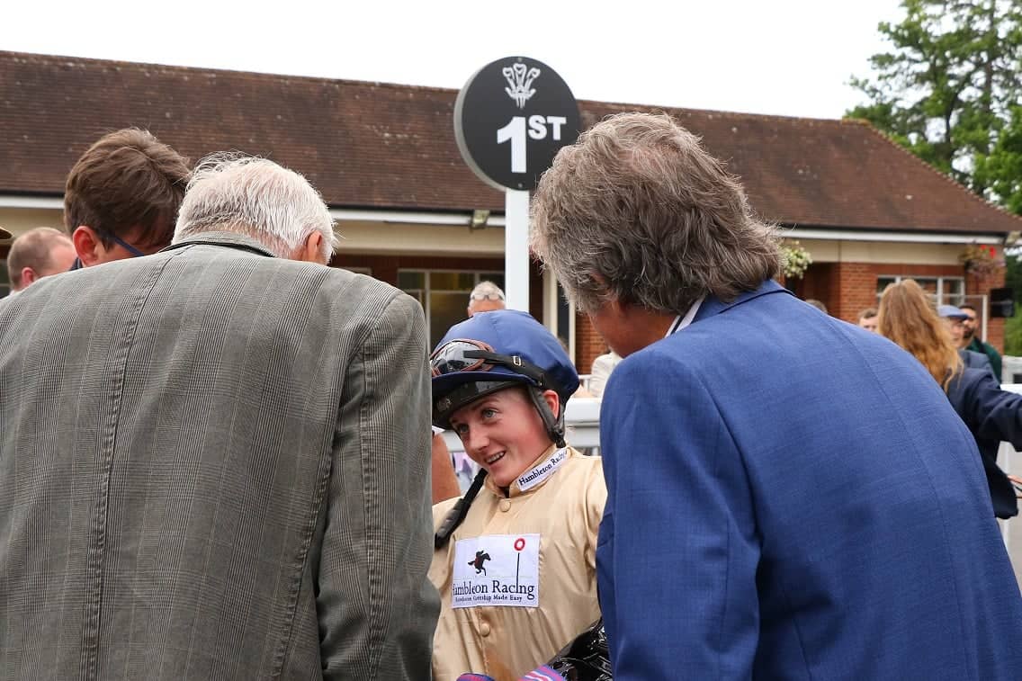 Hollie Doyle explaining to owners how their racehorse has won at Lingfield racecourse