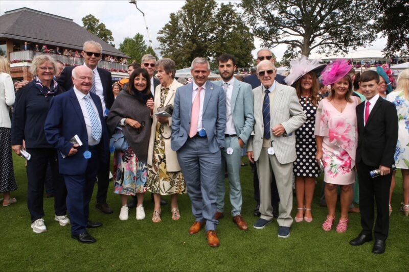 a large group of owners pose for a picture at York races