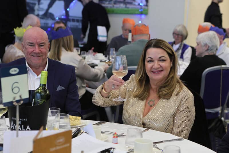 Guests cheers as they enjoy a Hambleton Racing social event.