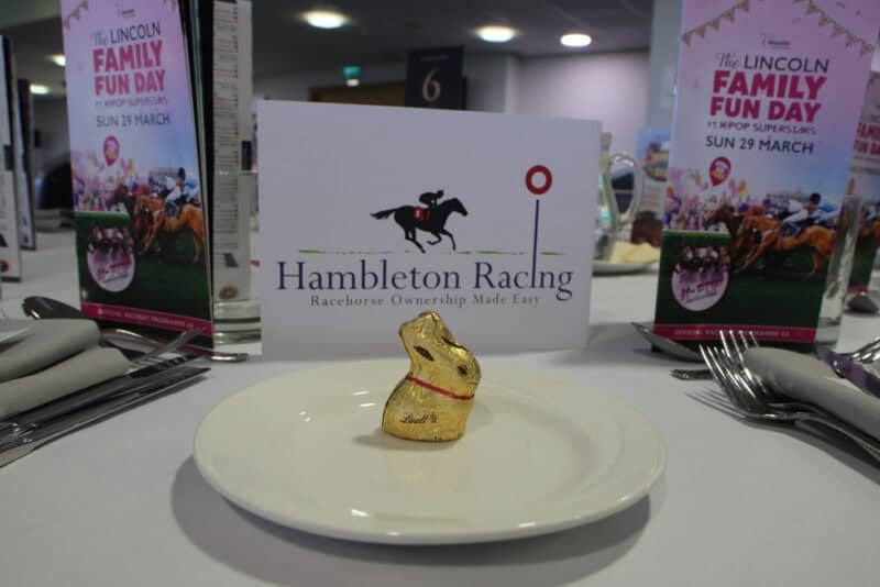 A Lindt chocolate bunny in front of Hambleton Racing's logo