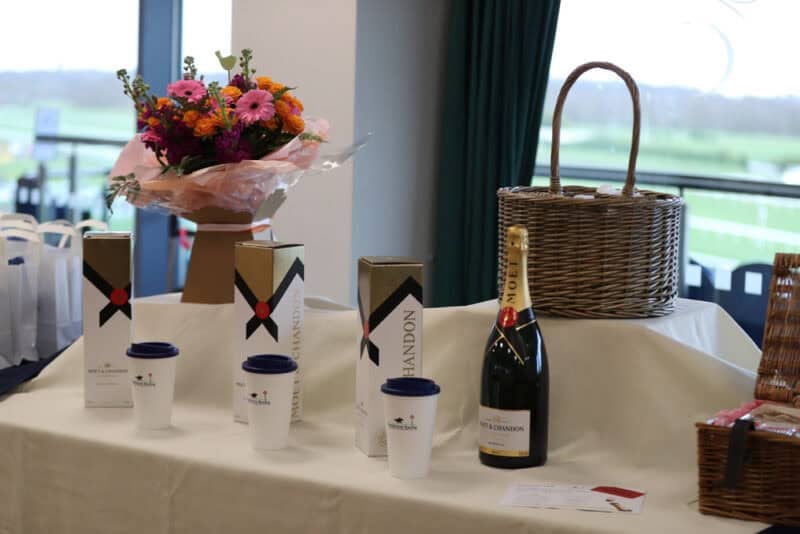 Moet and Chandon bottles on display with flowers on a table