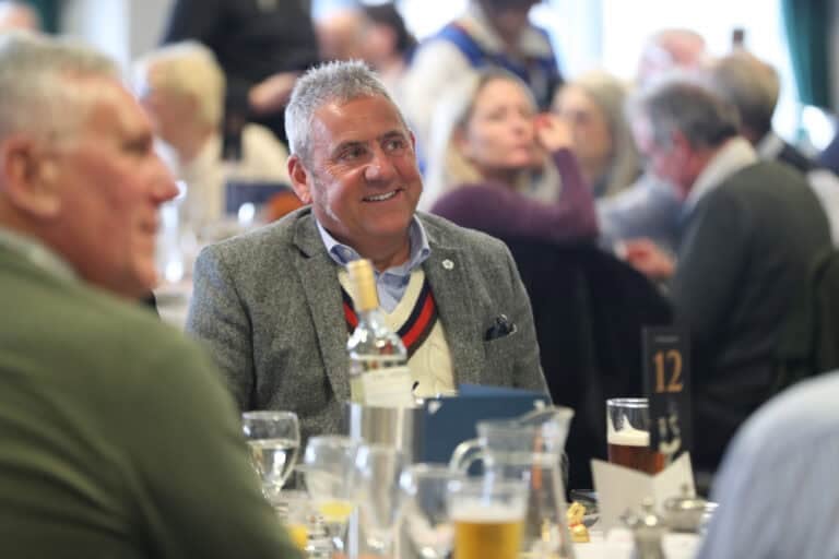 Hambleton Racing owners smiling and socialising at Doncaster Owners Day