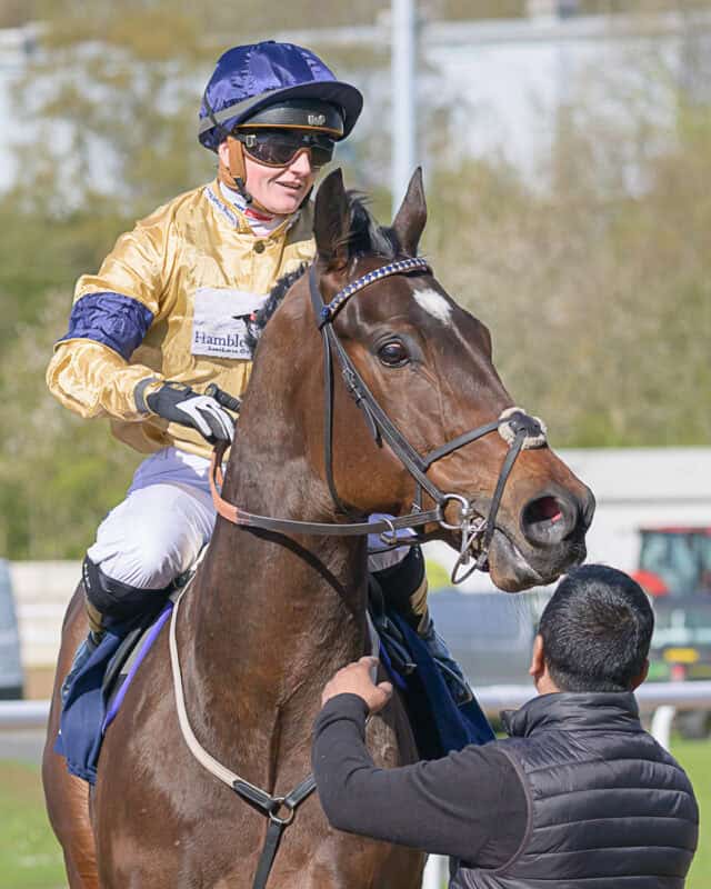 Hollie Doyle being greeted by a groom after winning aboard Elements Of Fire at Wolverhampton racecourse.