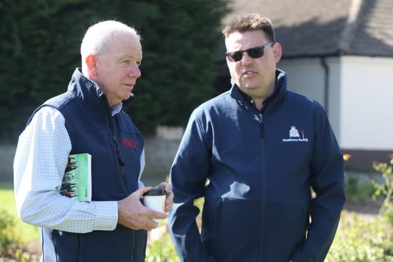 Horse Racing Trainer Karl Burke talks to Hambleton Racing's Cosmo Charlton at the stables