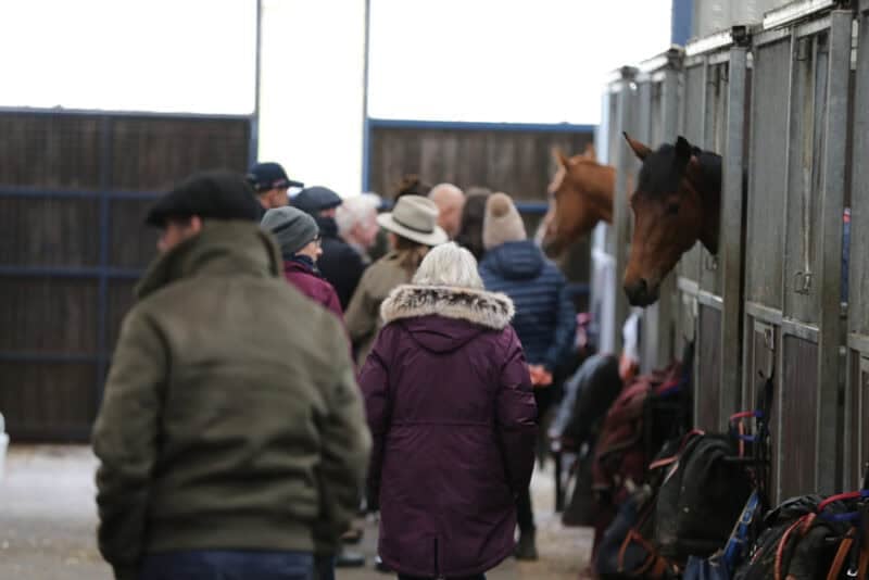 Owners exploring Karl Burke's yard at a Hambleton Racing naming day