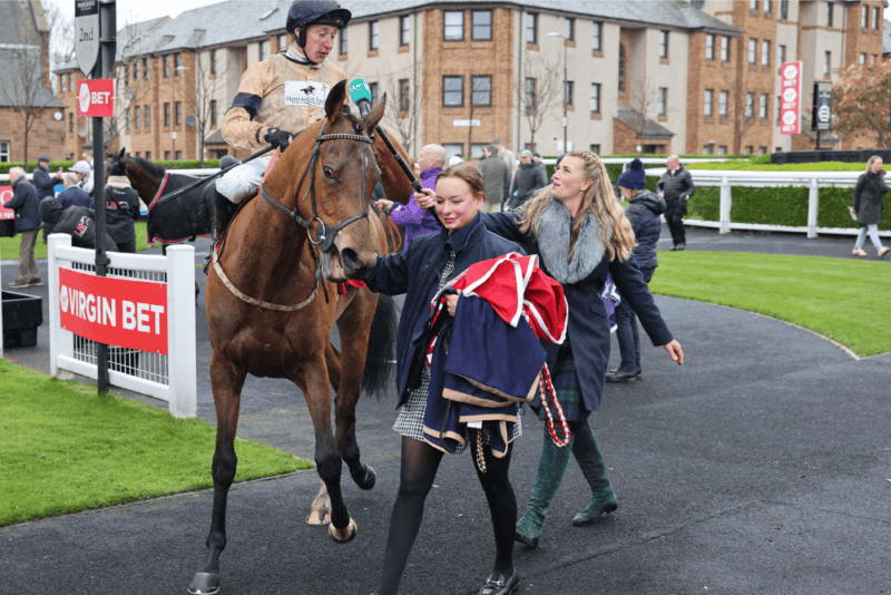 Sam James returns to the winners enclosure on a racehorse at Musselburgh racecourse.