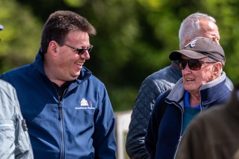 Men chatting at Tom Clover's owners' day in Newmarket