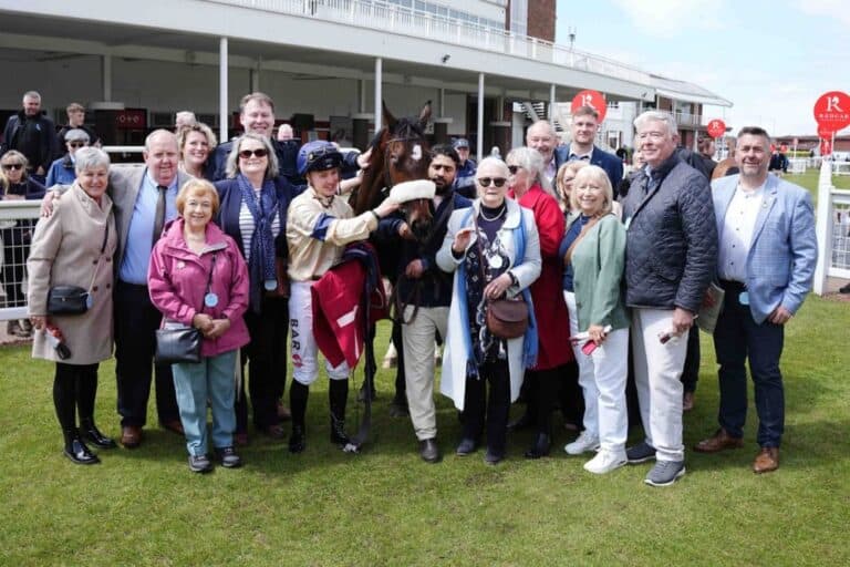 Winning owners of Kodiak Breeze in the winners enclosure with their horse.