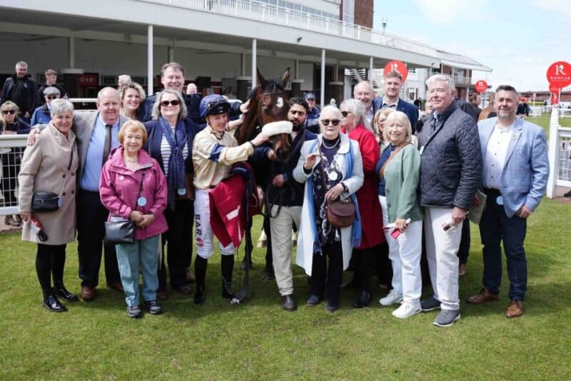 Winning owners of Kodiak Breeze in the winners enclosure with their horse.