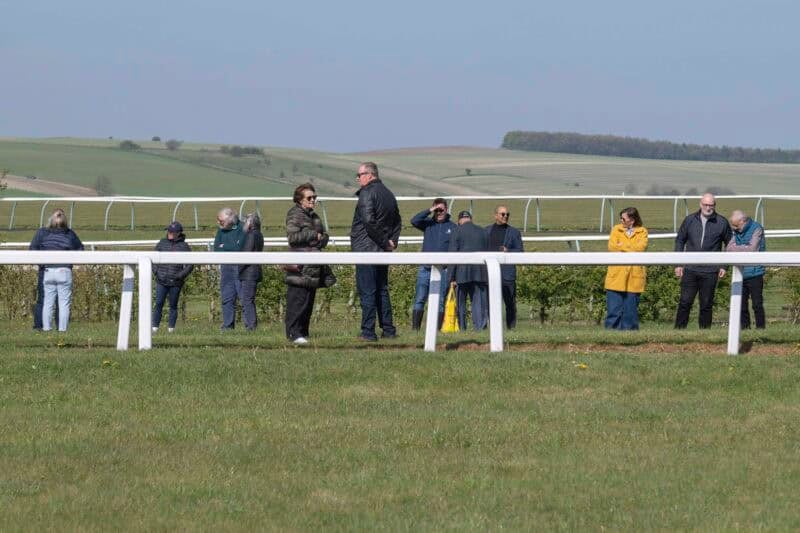 Owners waiting to watch their racehorse exercise on the gallops.